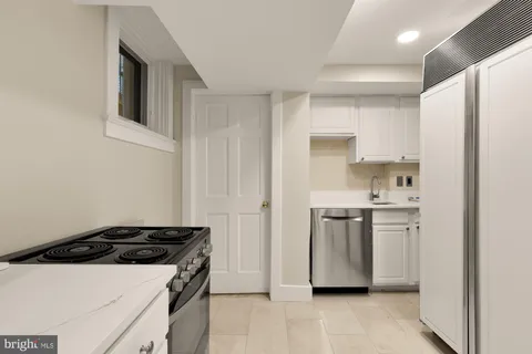 a kitchen with a stove and a refrigerator
