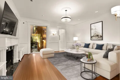 a living room with furniture fireplace and flat screen tv