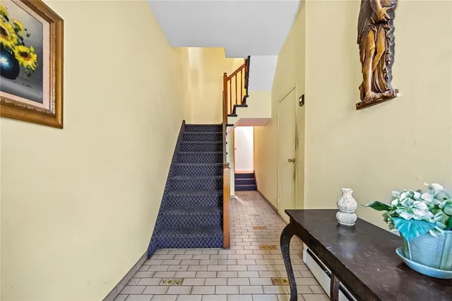 a view of a hallway with wooden floor and a potted plant