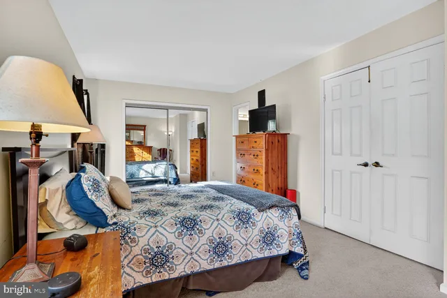 a bedroom with a bed and a lamp