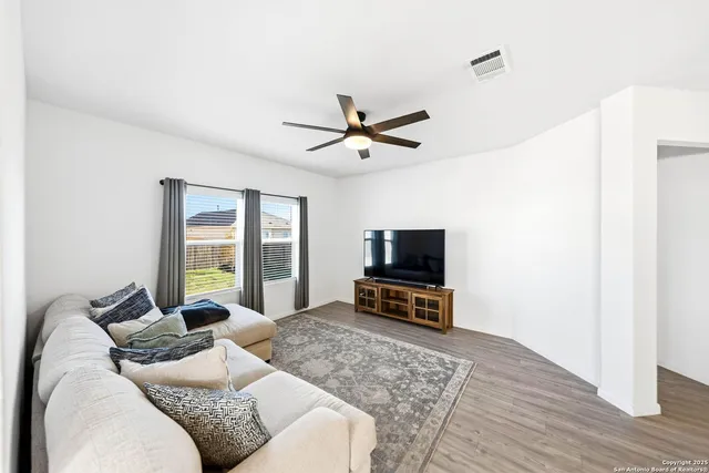 a living room with furniture and kitchen view