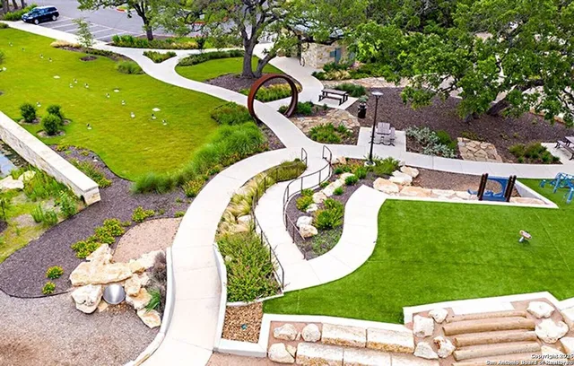 a view of a backyard with plants and outdoor seating