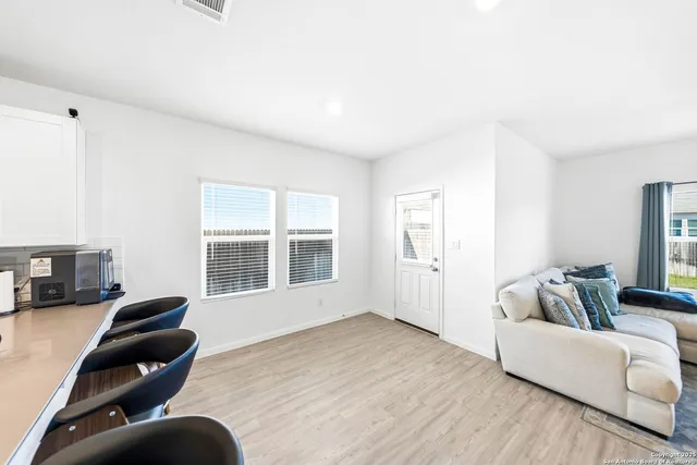 a view of a living room kitchen and a wooden floor