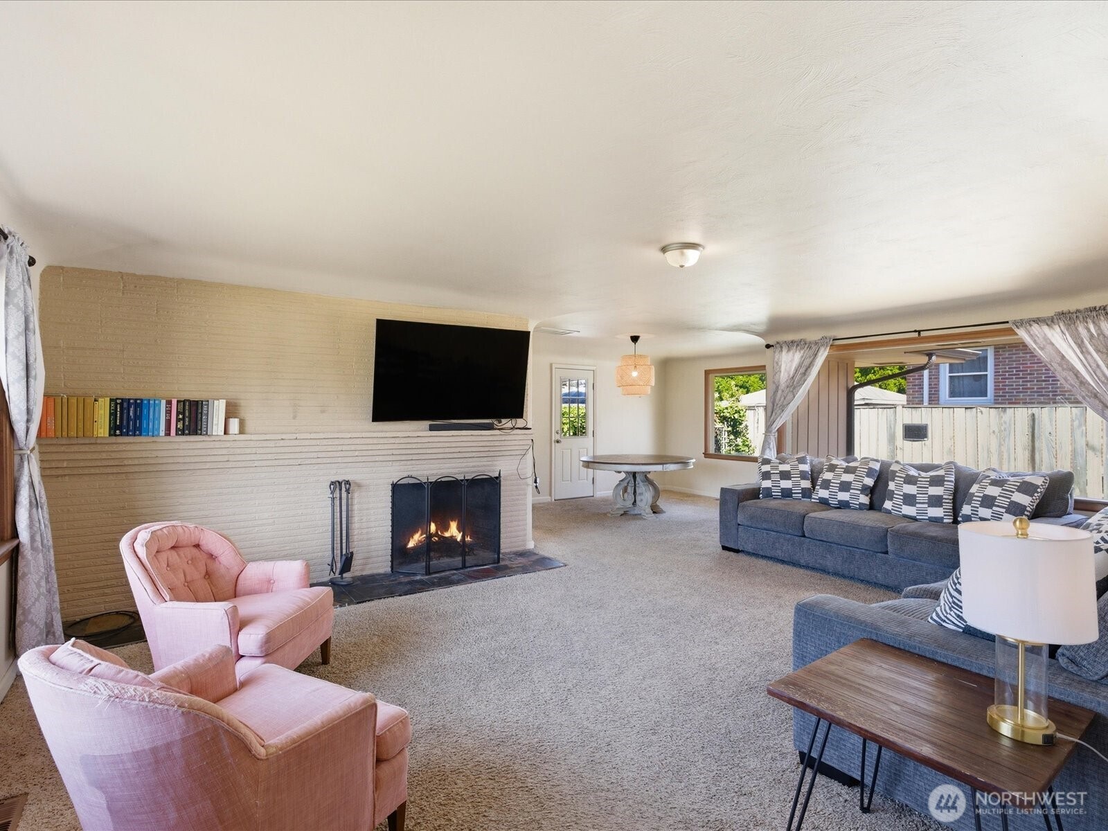 1417 Maple Street Sumner, WA 98390 - Photo 19 of 40 a living room with furniture a flat screen tv and a fireplace