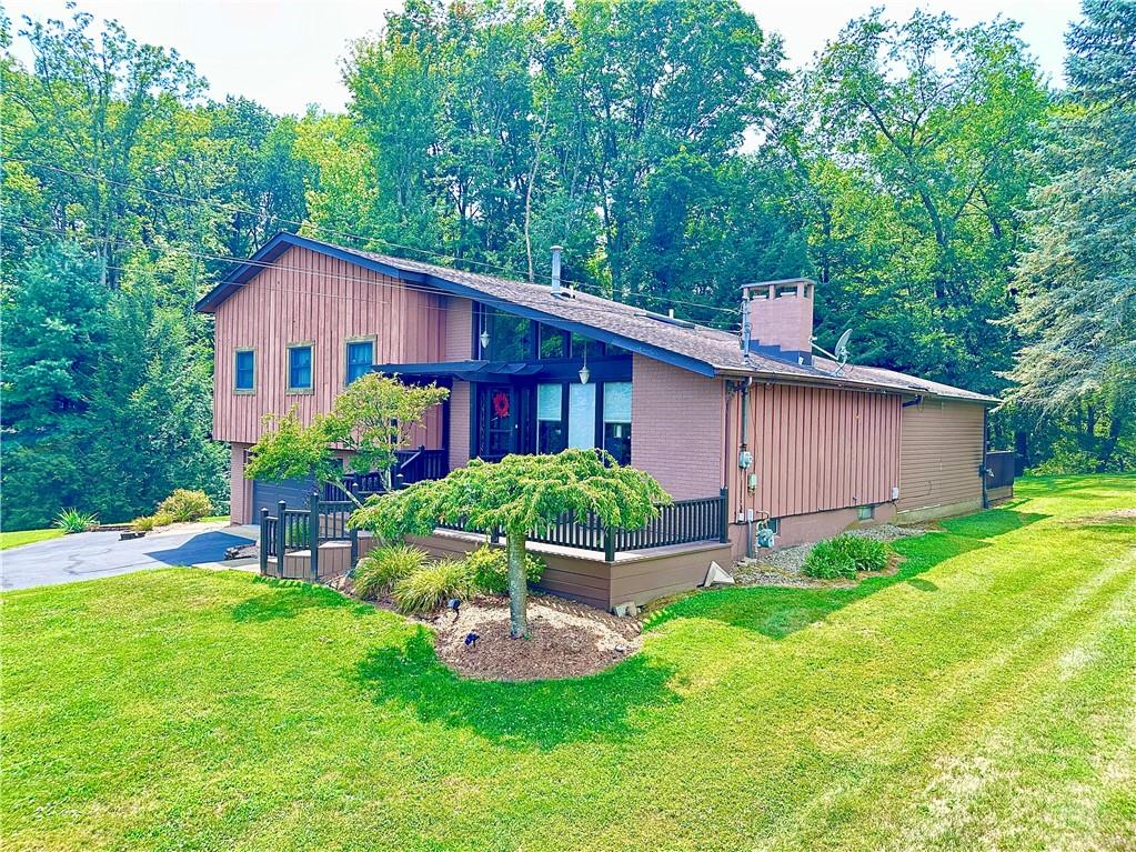 927 Chippewa Trail Mercer, PA 16137 - Photo 2 of 48 a view of backyard with table and chairs and potted plants and large trees