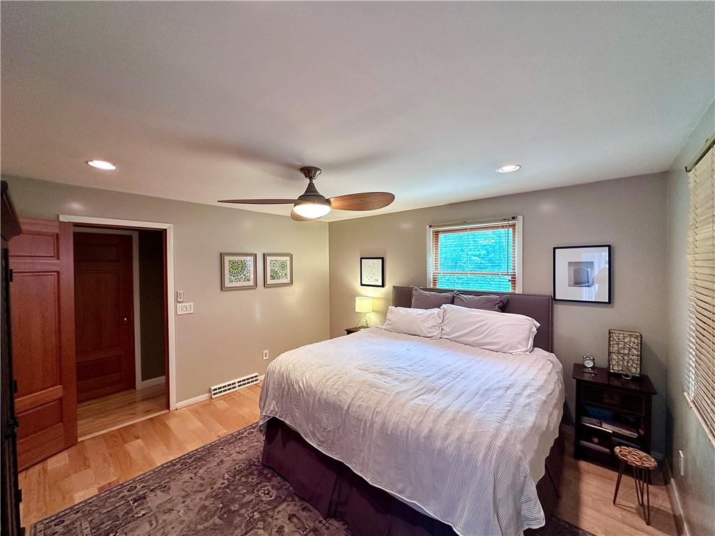 927 Chippewa Trail Mercer, PA 16137 - Photo 39 of 48 a bedroom with a large bed and a chandelier