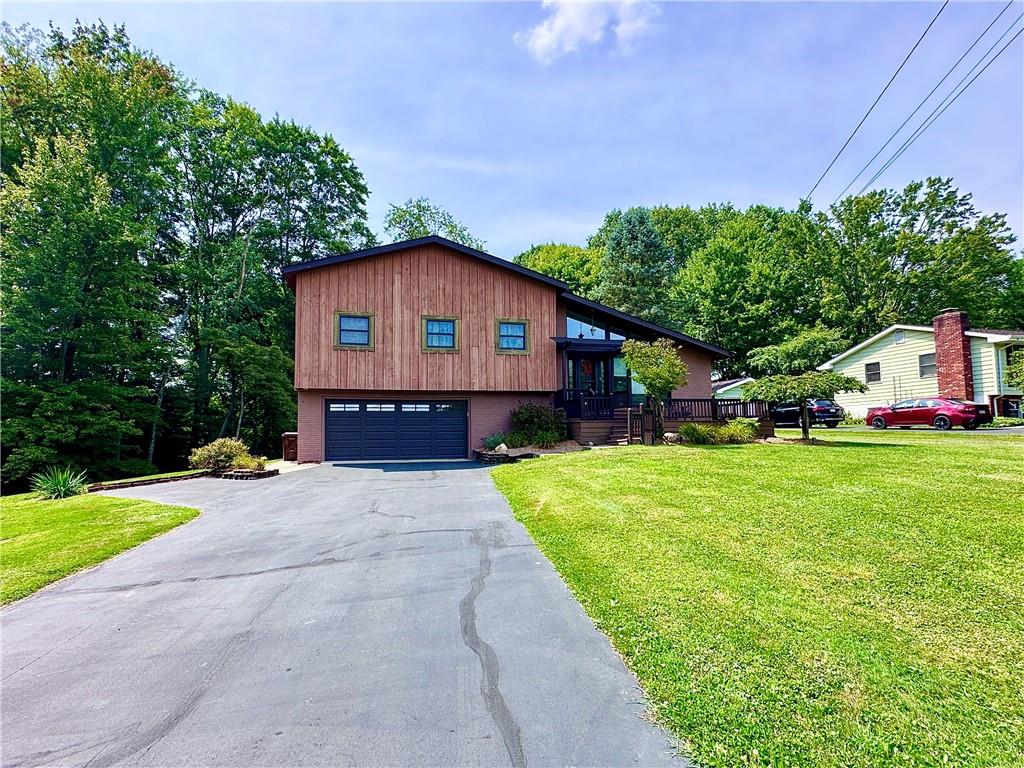 927 Chippewa Trail Mercer, PA 16137 - Photo 4 of 48 a front view of a house with a garden and deck