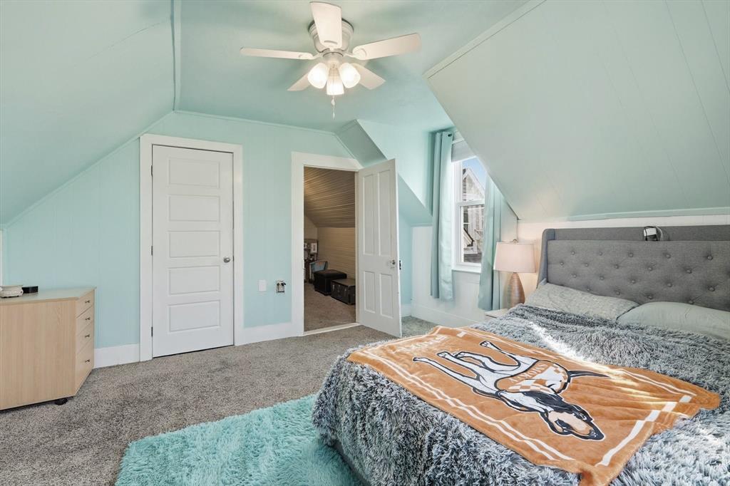 201 Shaffner Street Ponder, TX 76259 - Photo 34 of 40 a bedroom with a large bed and a chandelier