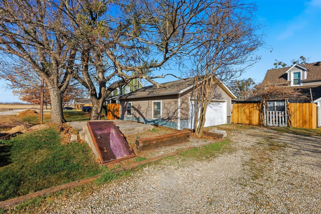 201 Shaffner Street Ponder, TX 76259 - Photo 4 of 40 a front view of a house with a yard and garage