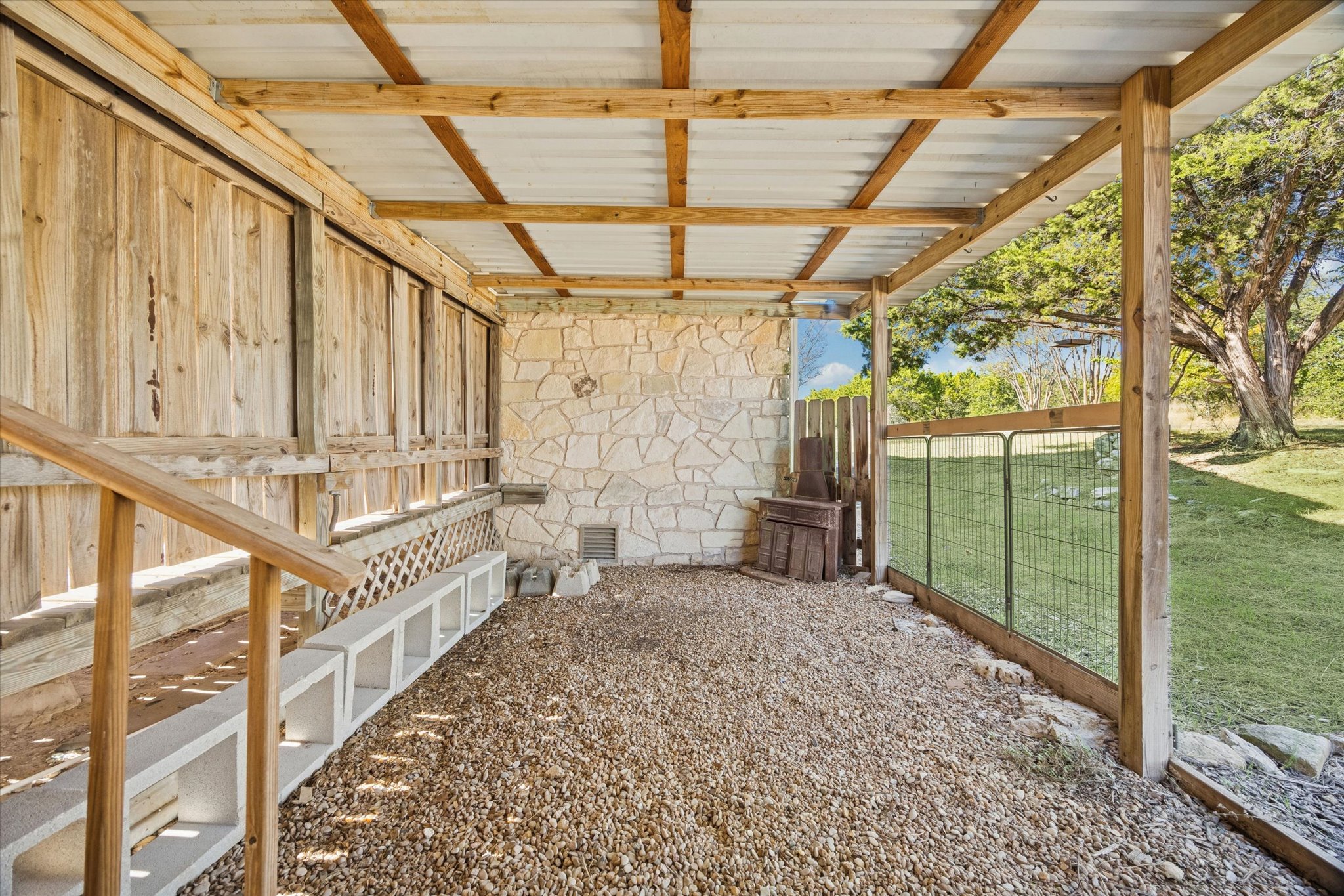 1091 Alta Vista Road Spicewood, TX 78669 - Photo 12 of 28 a view of a porch with wooden floor and iron stairs