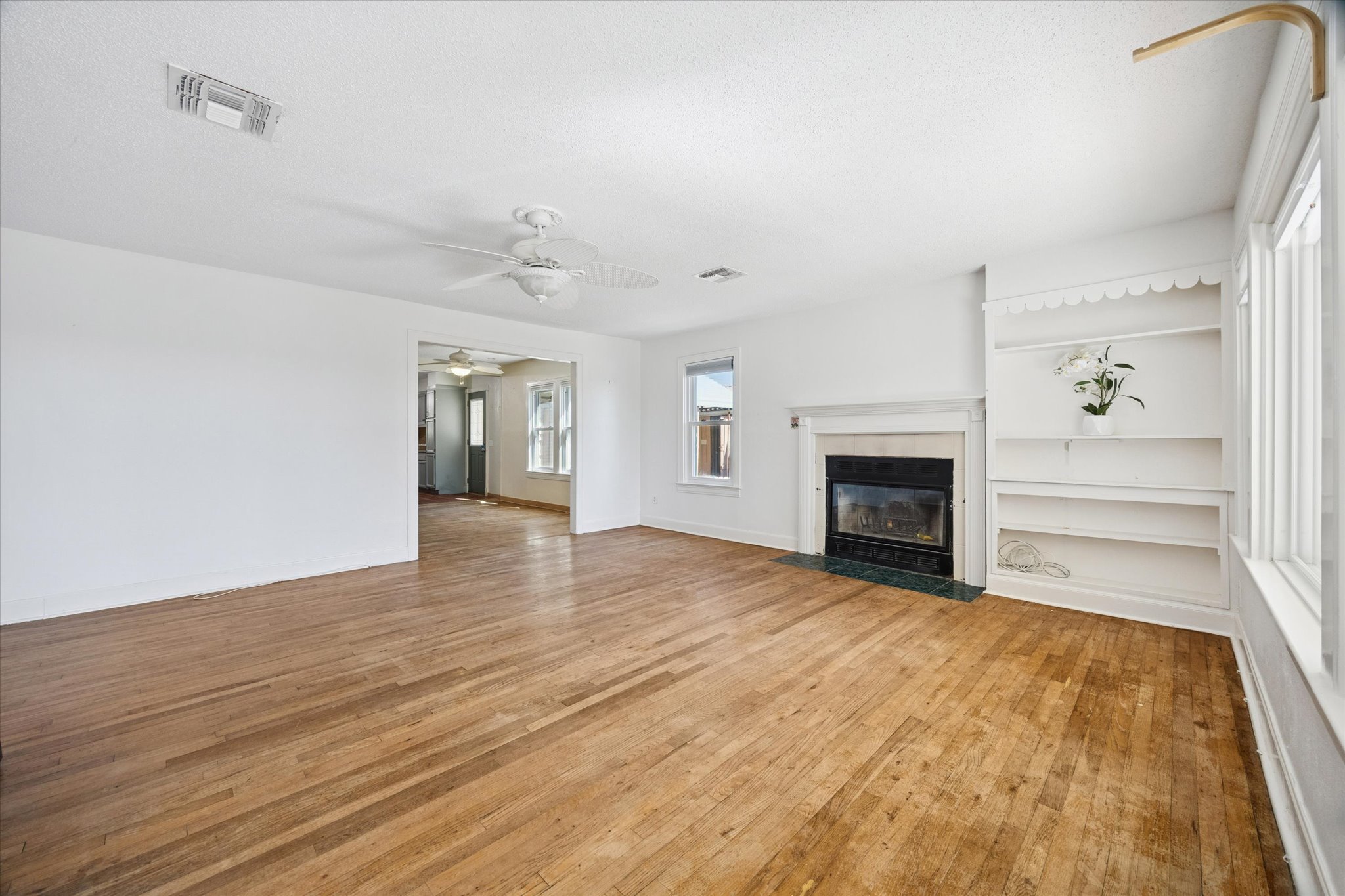 1091 Alta Vista Road Spicewood, TX 78669 - Photo 14 of 28 a view of empty room with wooden floor and fireplace