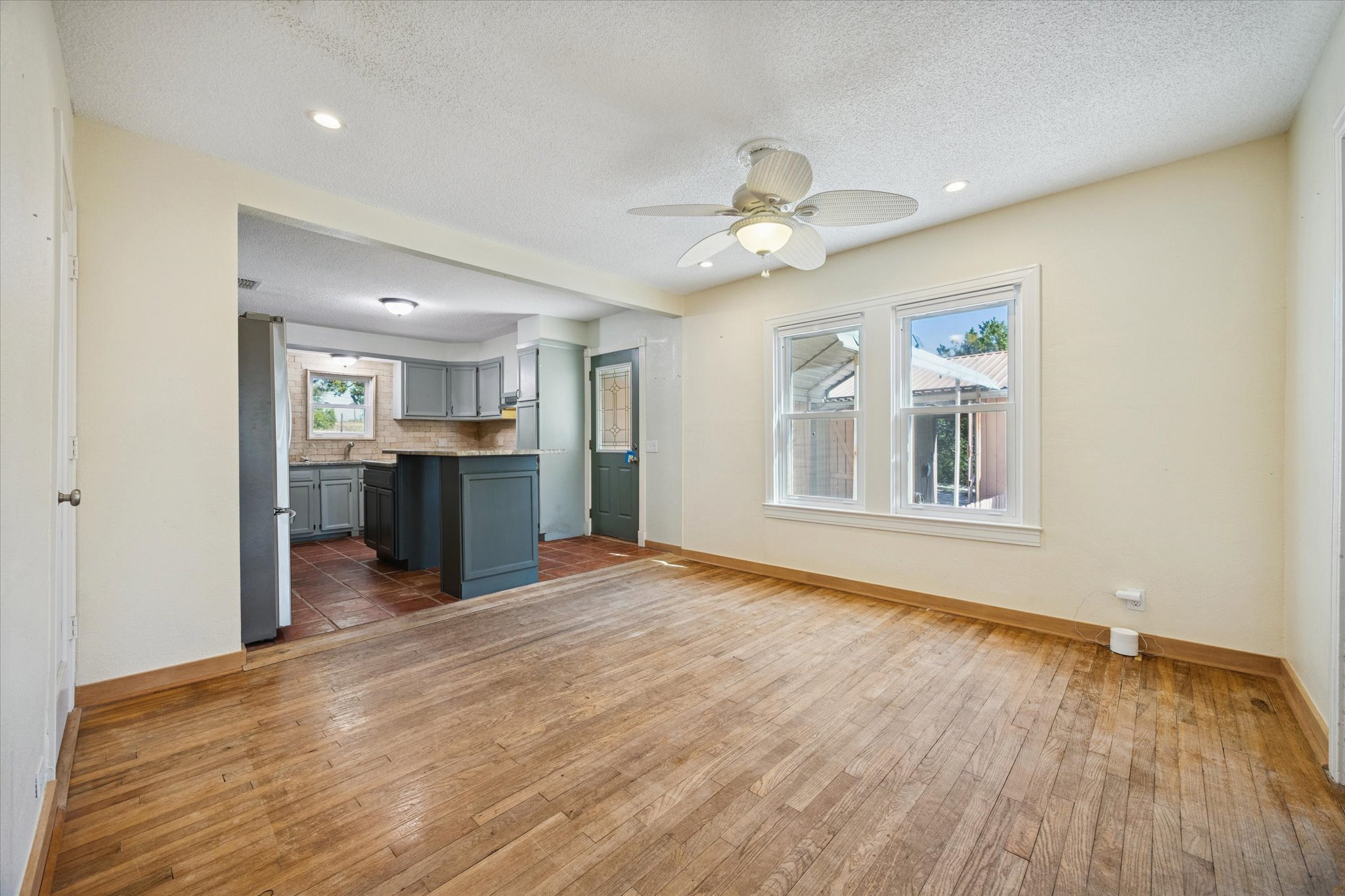 1091 Alta Vista Road Spicewood, TX 78669 - Photo 17 of 28 a view of an empty room with window and wooden floor