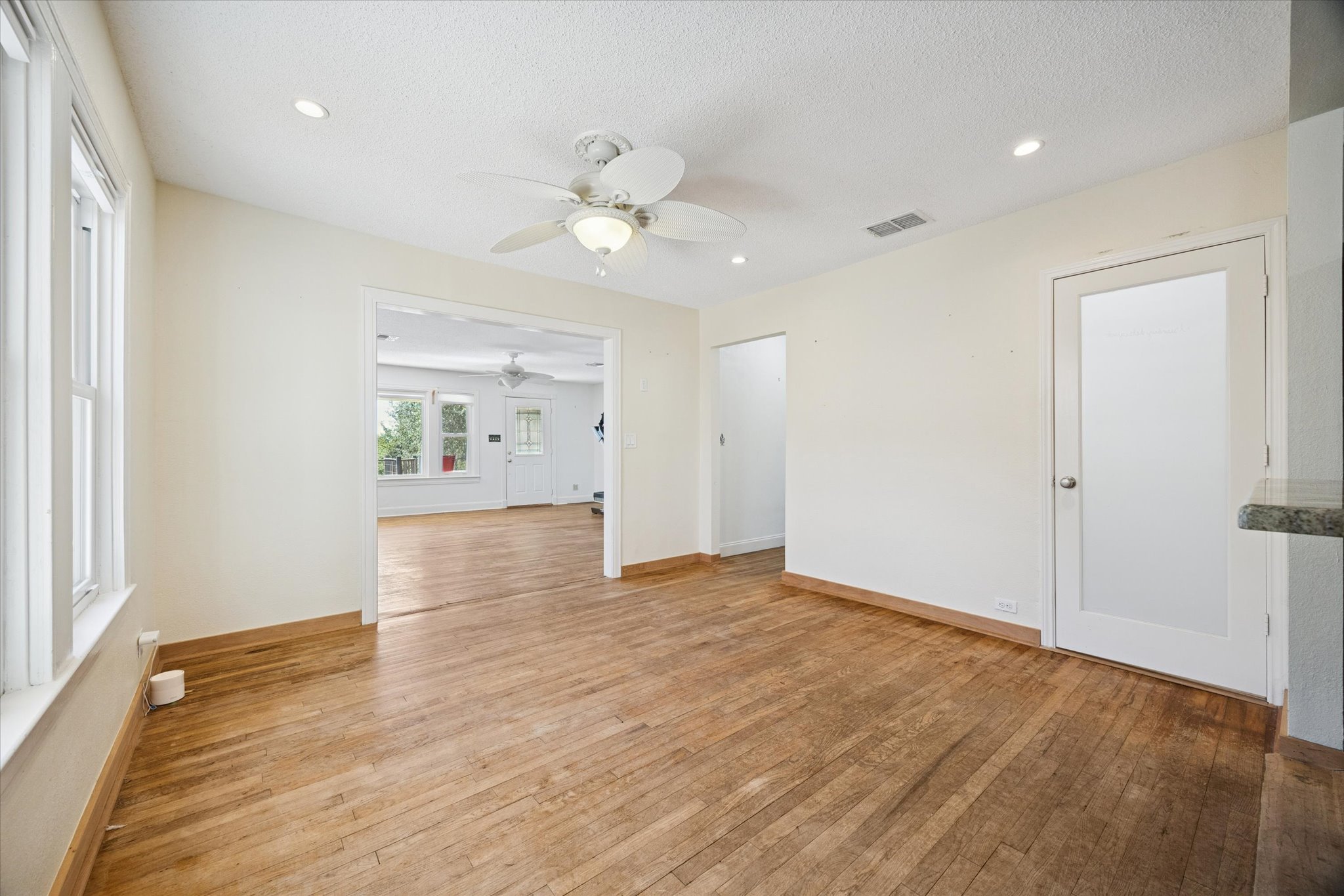 1091 Alta Vista Road Spicewood, TX 78669 - Photo 18 of 28 wooden floor in an empty room with a window