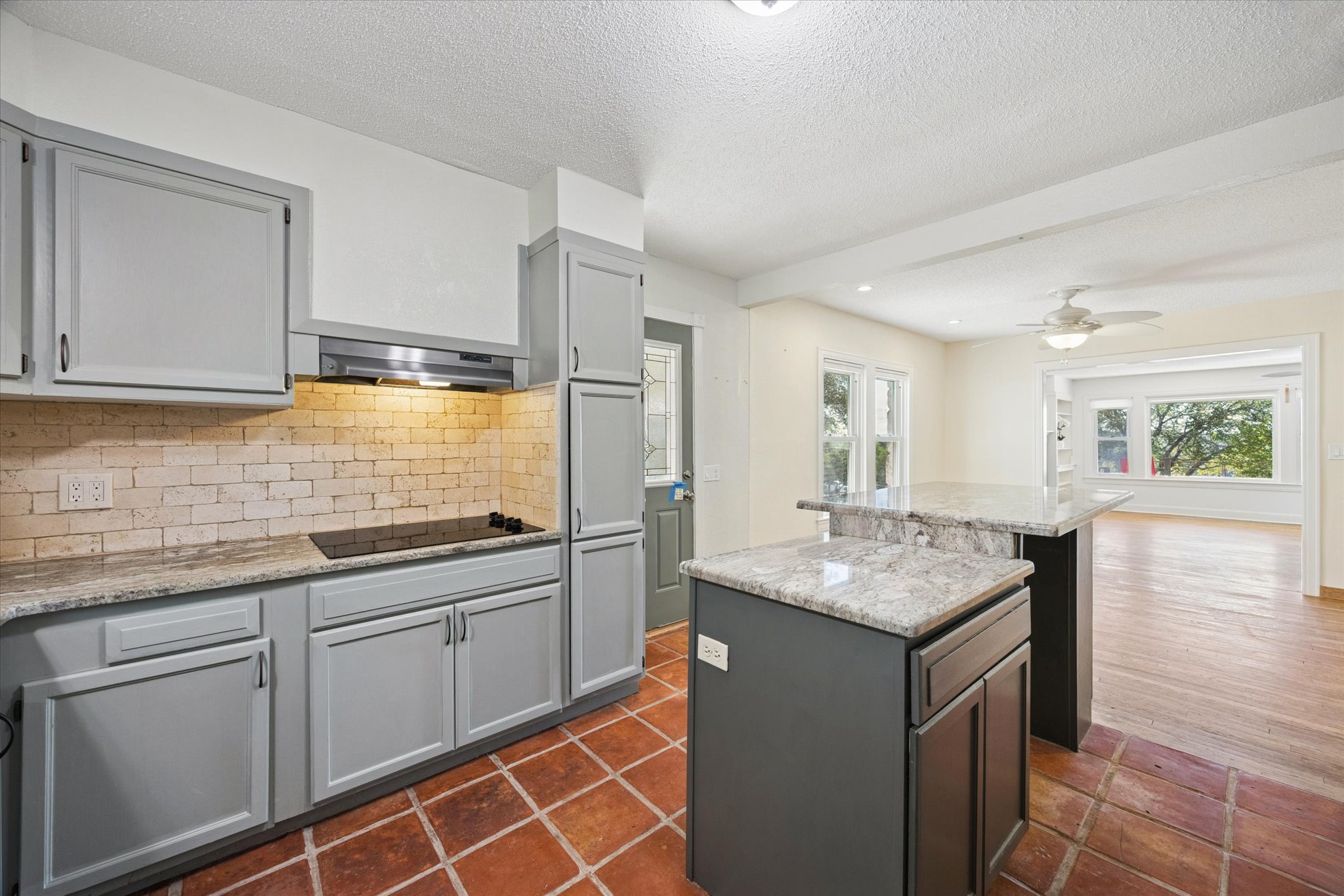 1091 Alta Vista Road Spicewood, TX 78669 - Photo 20 of 28 a kitchen with sink cabinets and wooden floor
