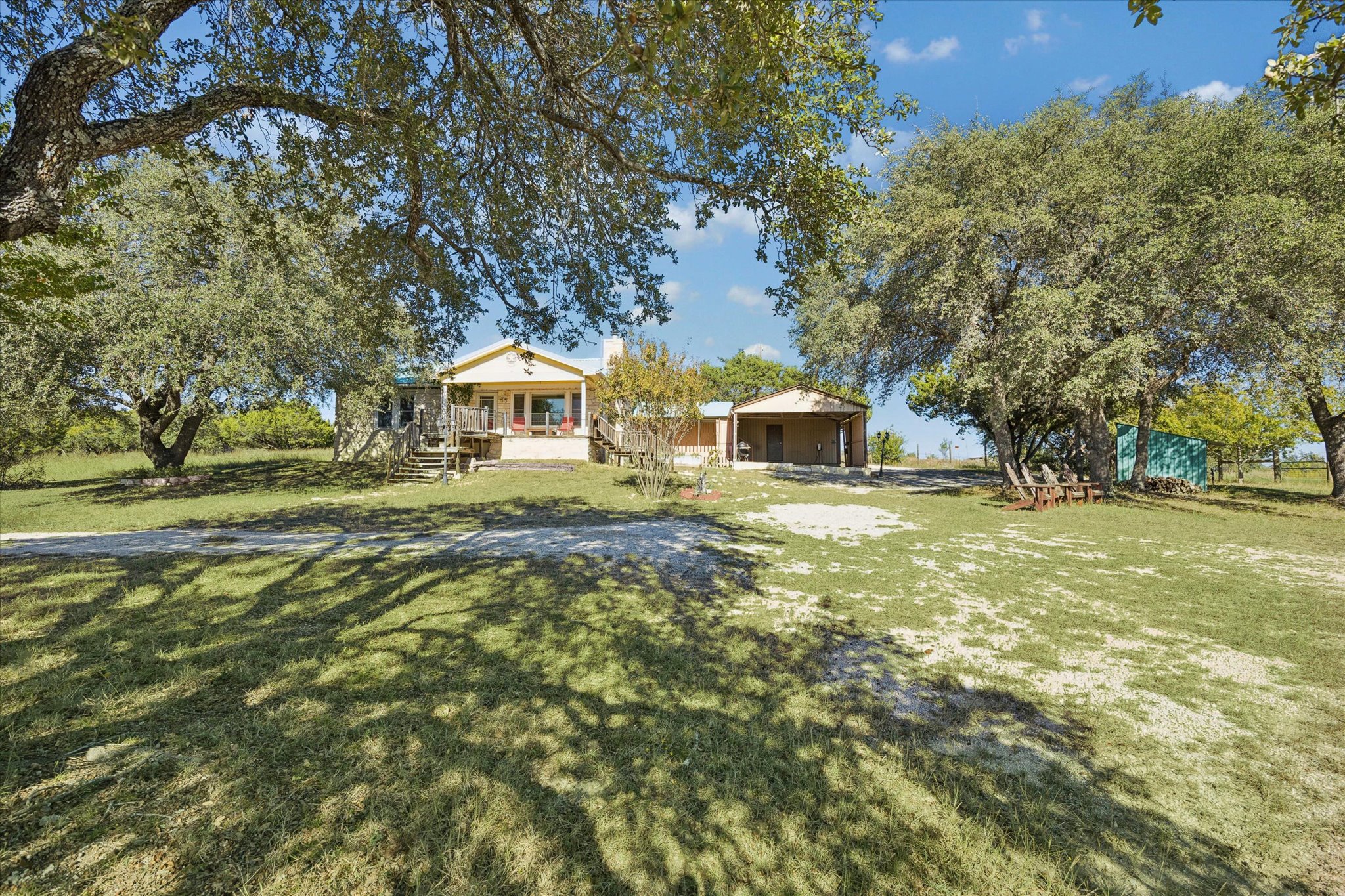 1091 Alta Vista Road Spicewood, TX 78669 - Photo 2 of 28 a front view of a house with a yard