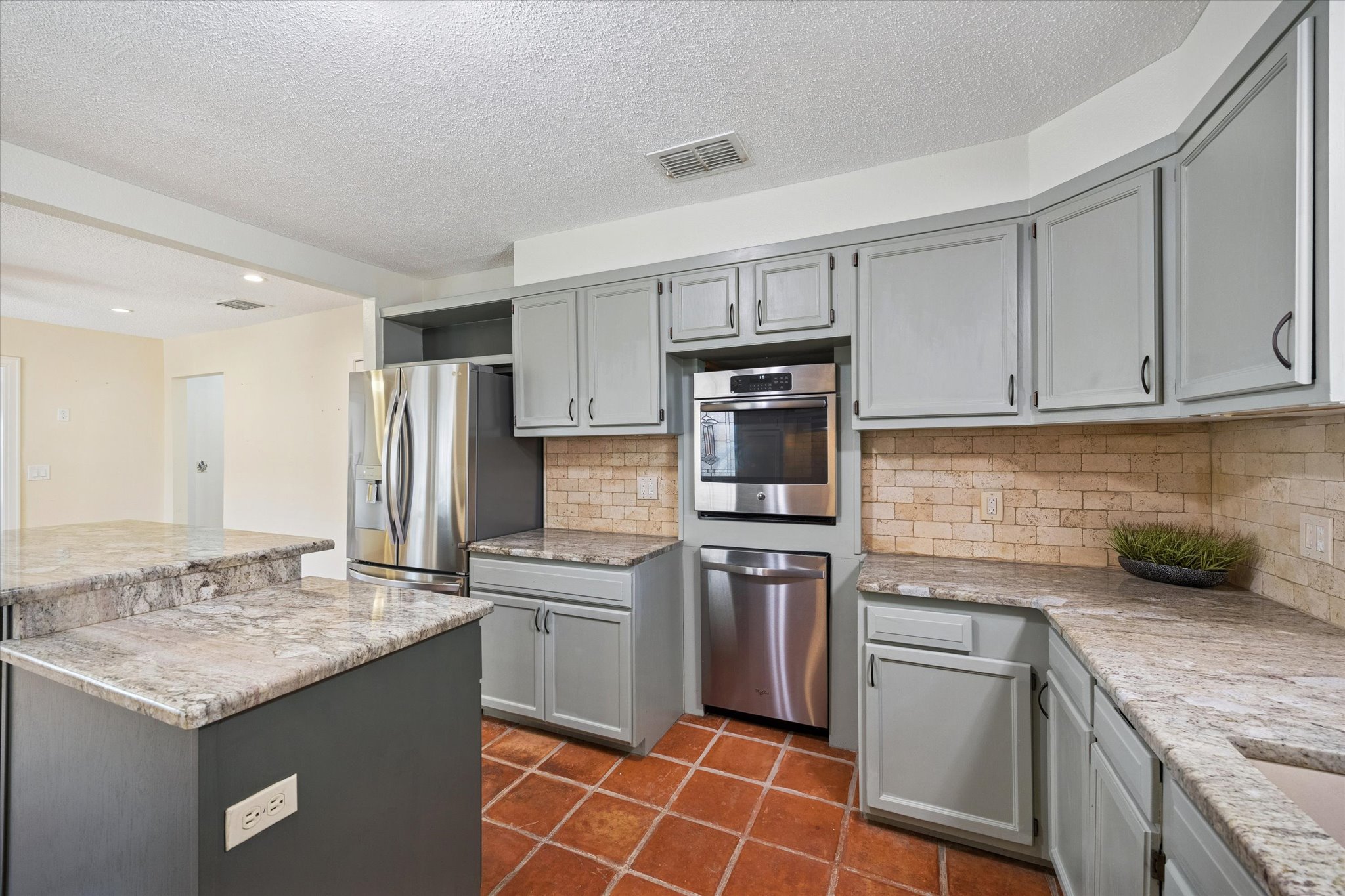 1091 Alta Vista Road Spicewood, TX 78669 - Photo 21 of 28 a kitchen with stainless steel appliances granite countertop a sink stove and refrigerator
