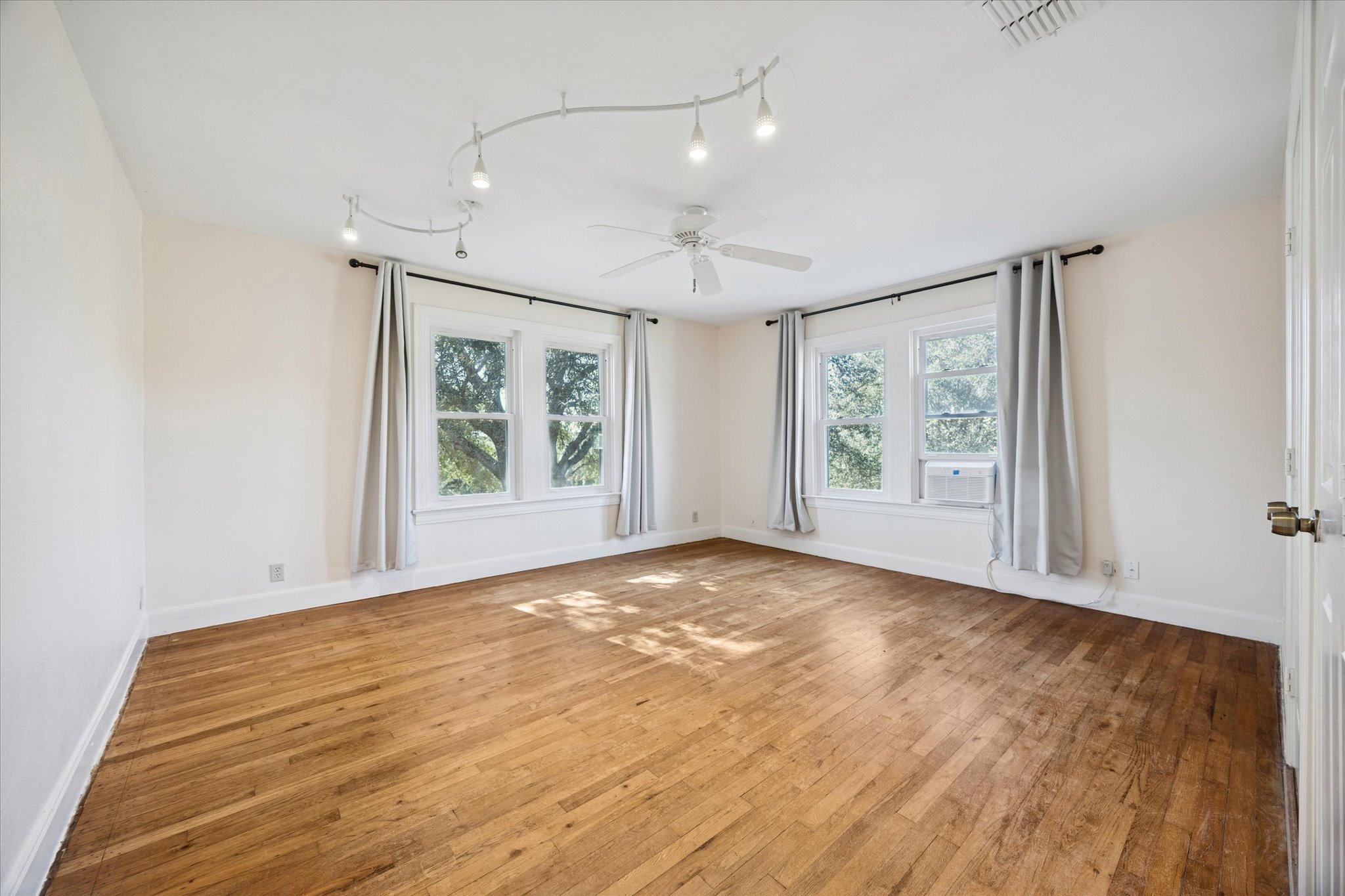 1091 Alta Vista Road Spicewood, TX 78669 - Photo 22 of 28 wooden floor in an empty room with a window