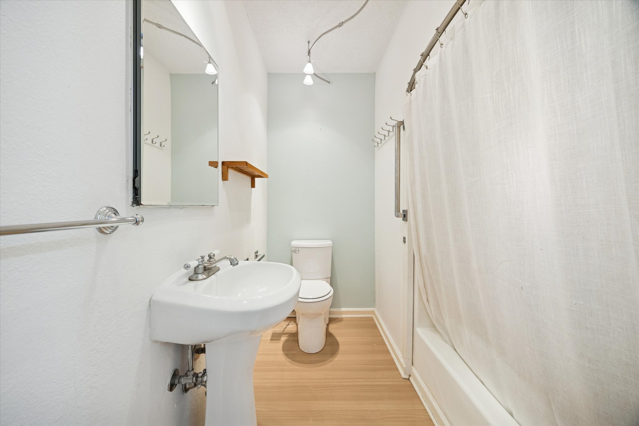 1091 Alta Vista Road Spicewood, TX 78669 - Photo 23 of 28 a bathroom with a sink a toilet and shower