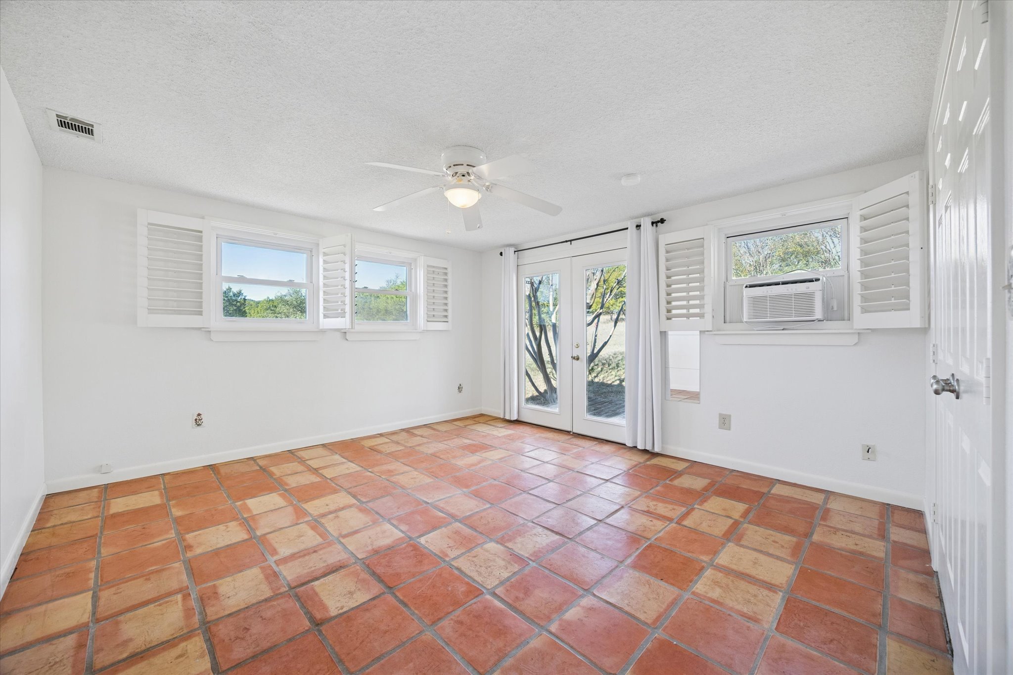 1091 Alta Vista Road Spicewood, TX 78669 - Photo 25 of 28 a view of an empty room with a window