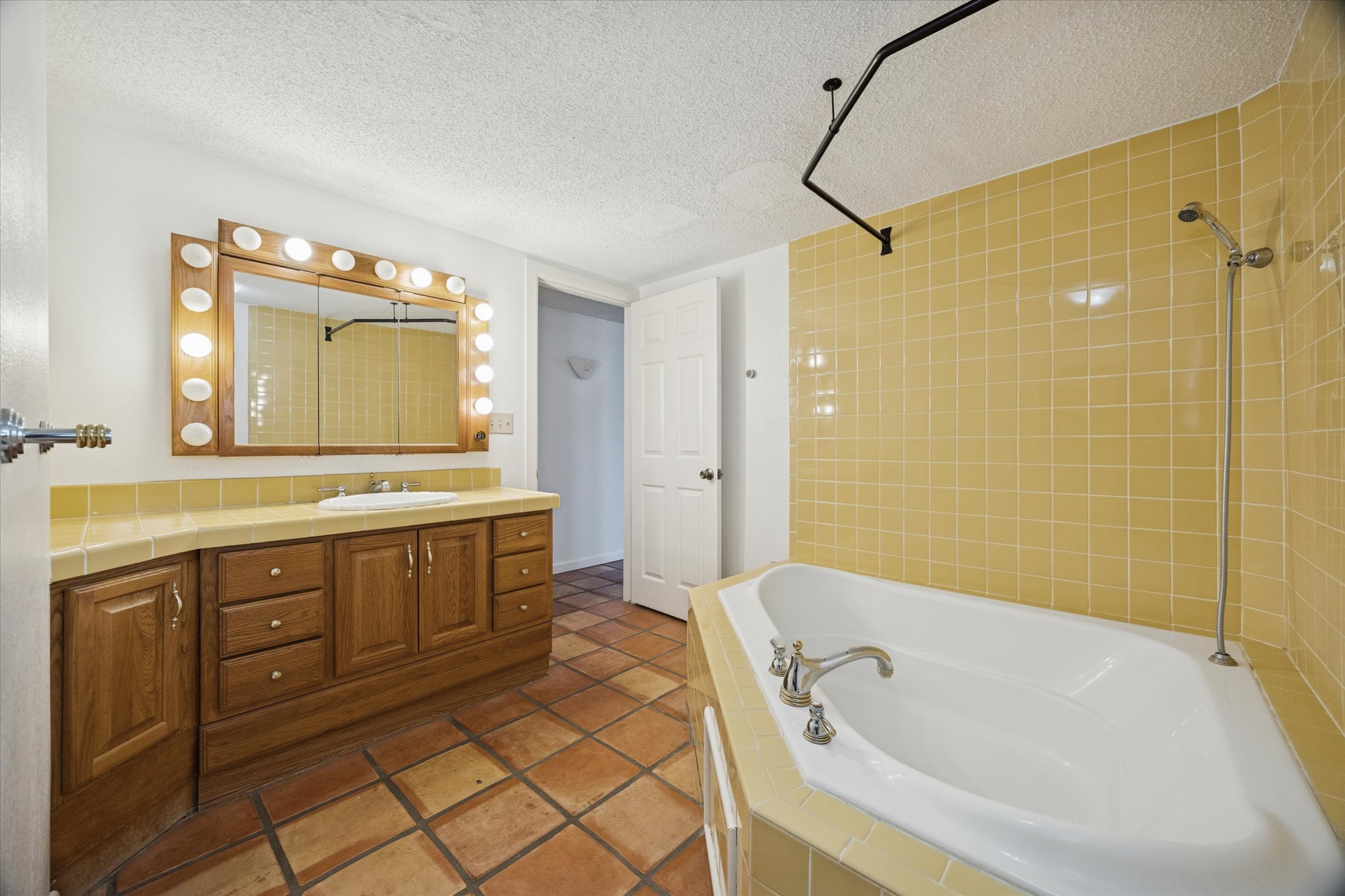 1091 Alta Vista Road Spicewood, TX 78669 - Photo 28 of 28 a bathroom with a tub sink and a mirror