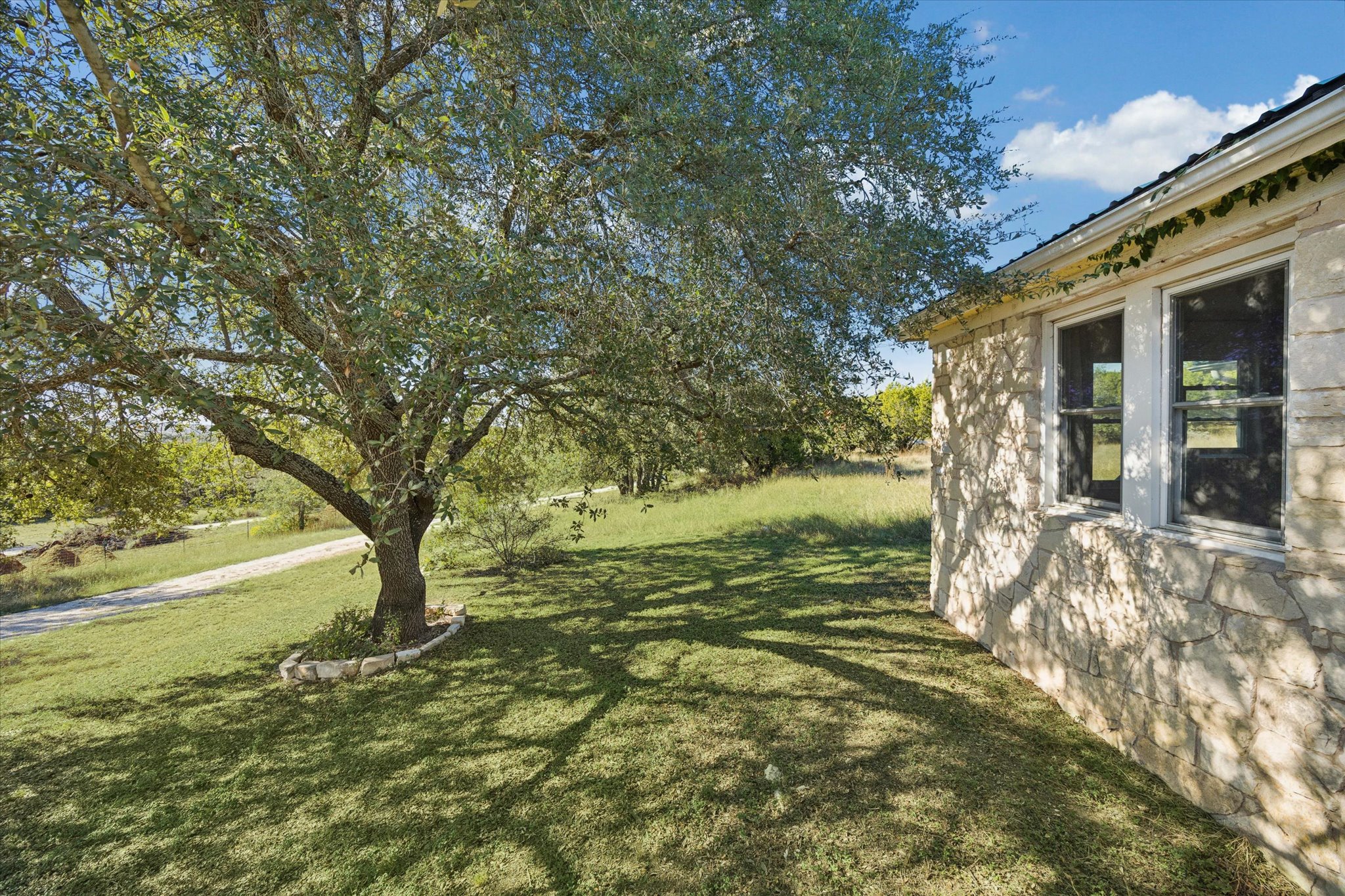 1091 Alta Vista Road Spicewood, TX 78669 - Photo 7 of 28 a view of a house with a yard