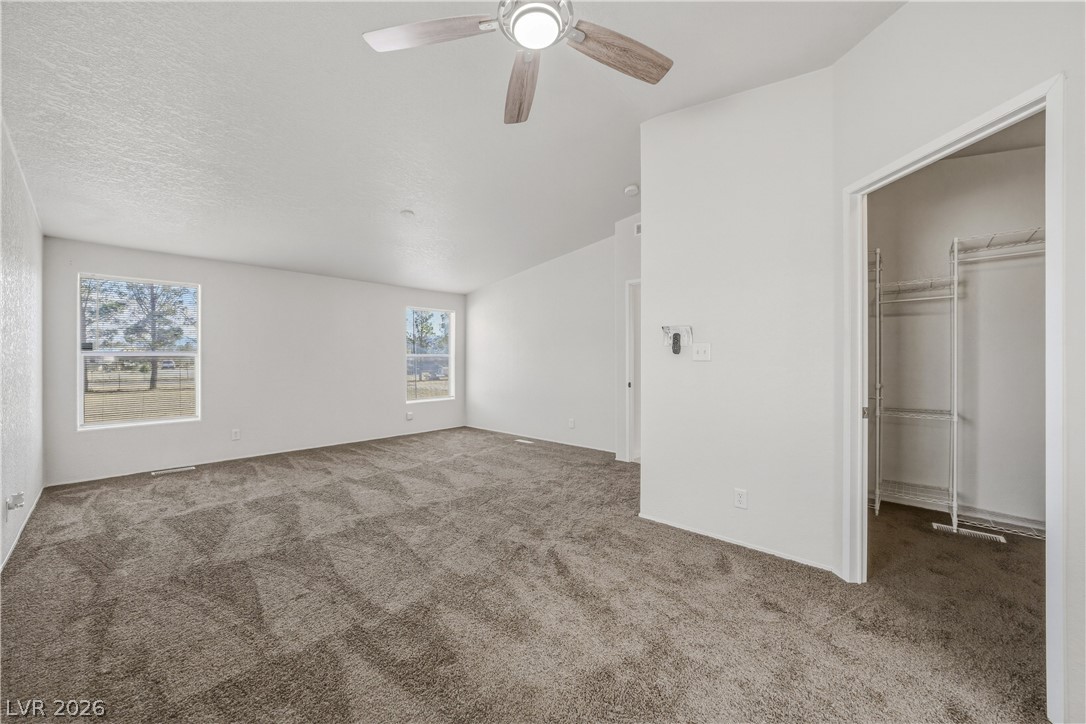 1890 West Dyer Road Pahrump, NV 89048 - Photo 7 of 40 Bright and airy, this bedroom features ample natural light and a functional closet system.