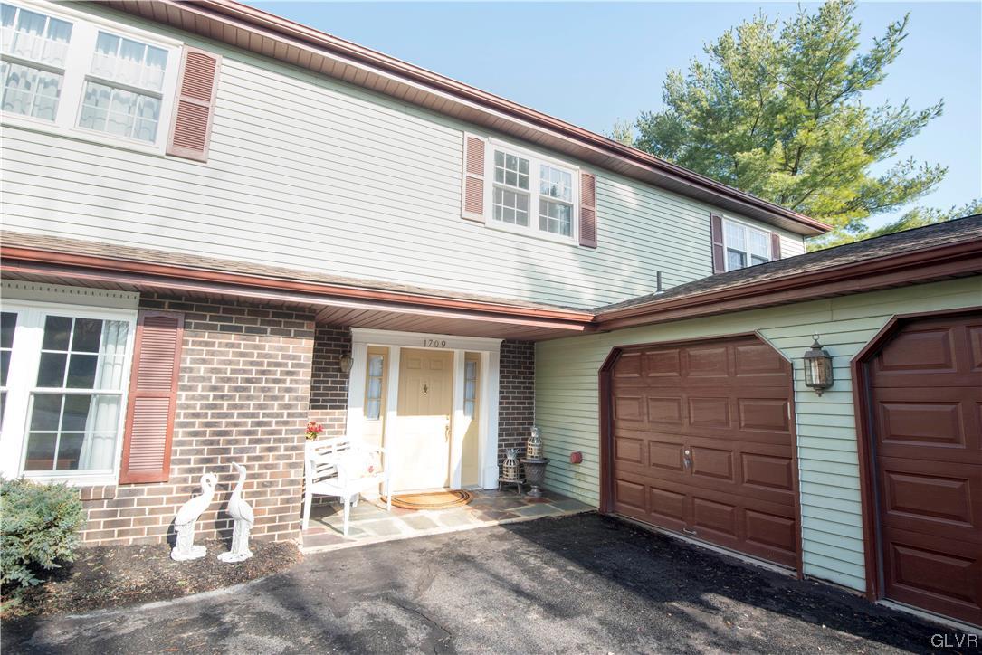 WIDE COVERED FRONT ENTRY IS BOTH PRACTICAL AND WEL