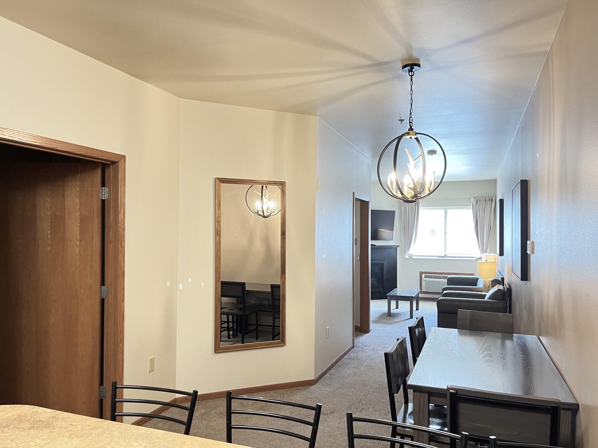 Undisclosed Address Lyons, WI 53147 - Photo 6 of 17 Kitchen opens to dinette area and living room. Doorway on left is a full bath. Further down on left is bedroom.
