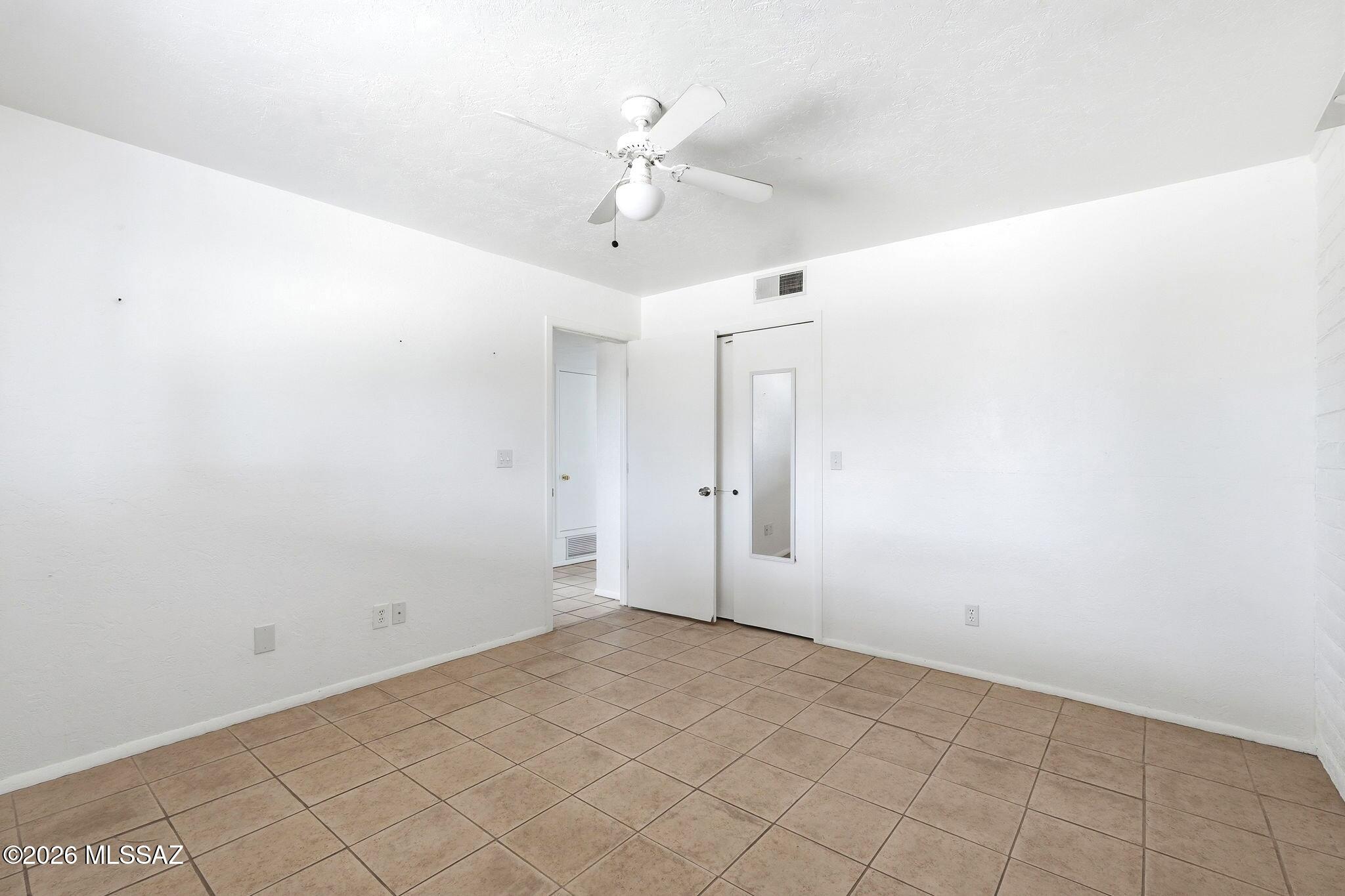 5125 South Missiondale Road Tucson, AZ 85706 - Photo 16 of 32 en empty room with white walls and ceiling fan
