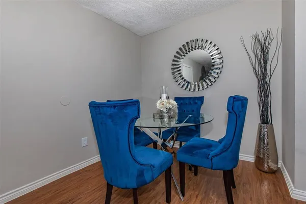 a view of a dining room with furniture and wooden floor