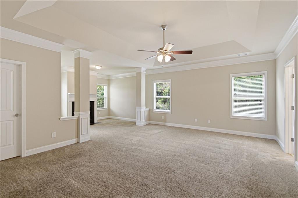 114 Madison Street Canton, GA 30115 - Photo 19 of 39 an empty room with chandelier fan and windows