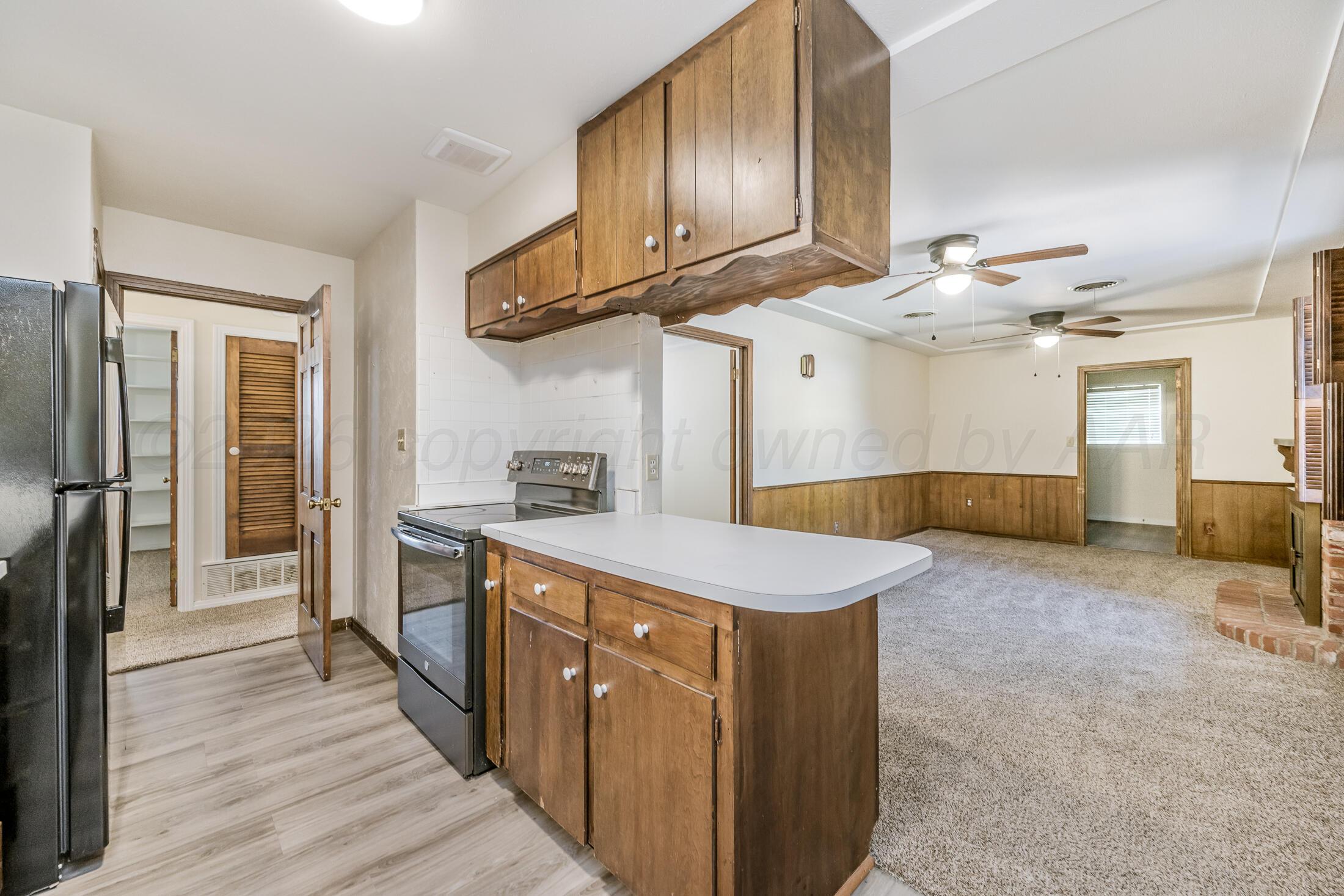 5408 George Terrace Amarillo, TX 79106 - Photo 11 of 26 a kitchen with cabinets and wooden floor