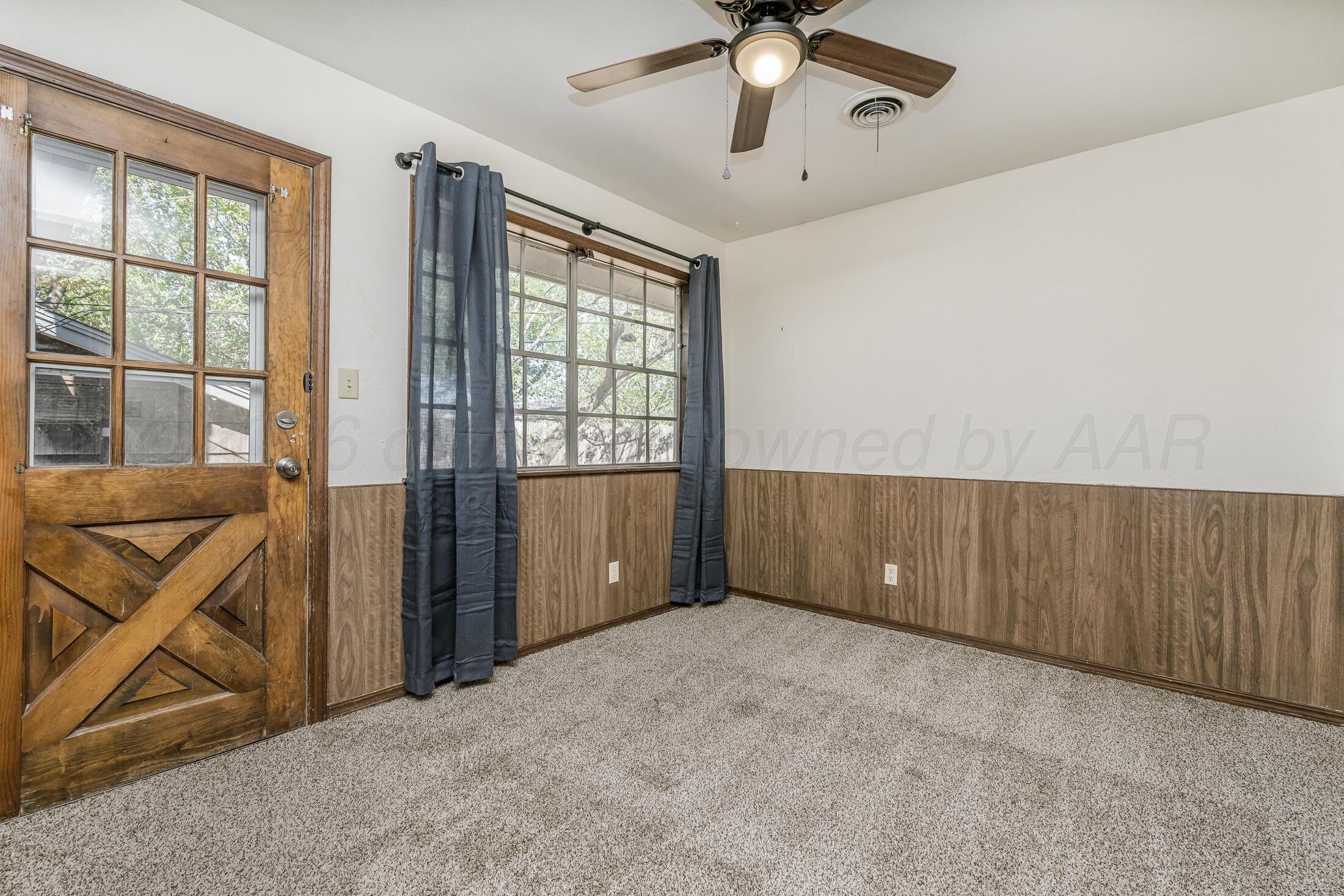 5408 George Terrace Amarillo, TX 79106 - Photo 13 of 26 an empty room with chandelier fan and windows