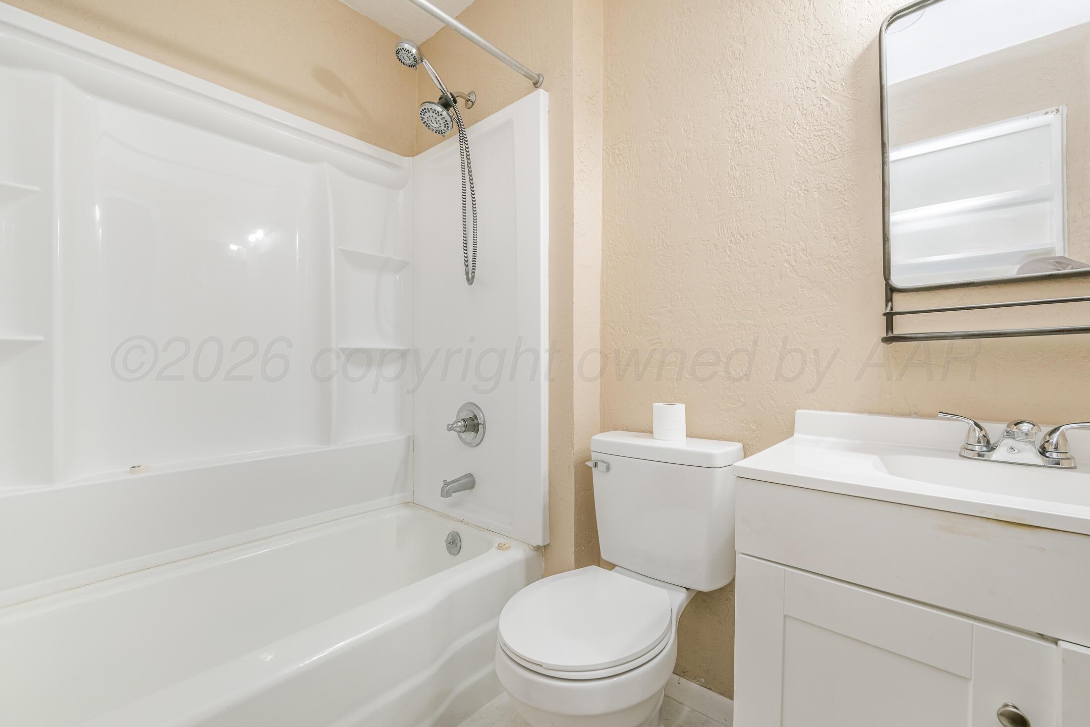 5408 George Terrace Amarillo, TX 79106 - Photo 18 of 26 a bathroom with a sink toilet vanity and shower