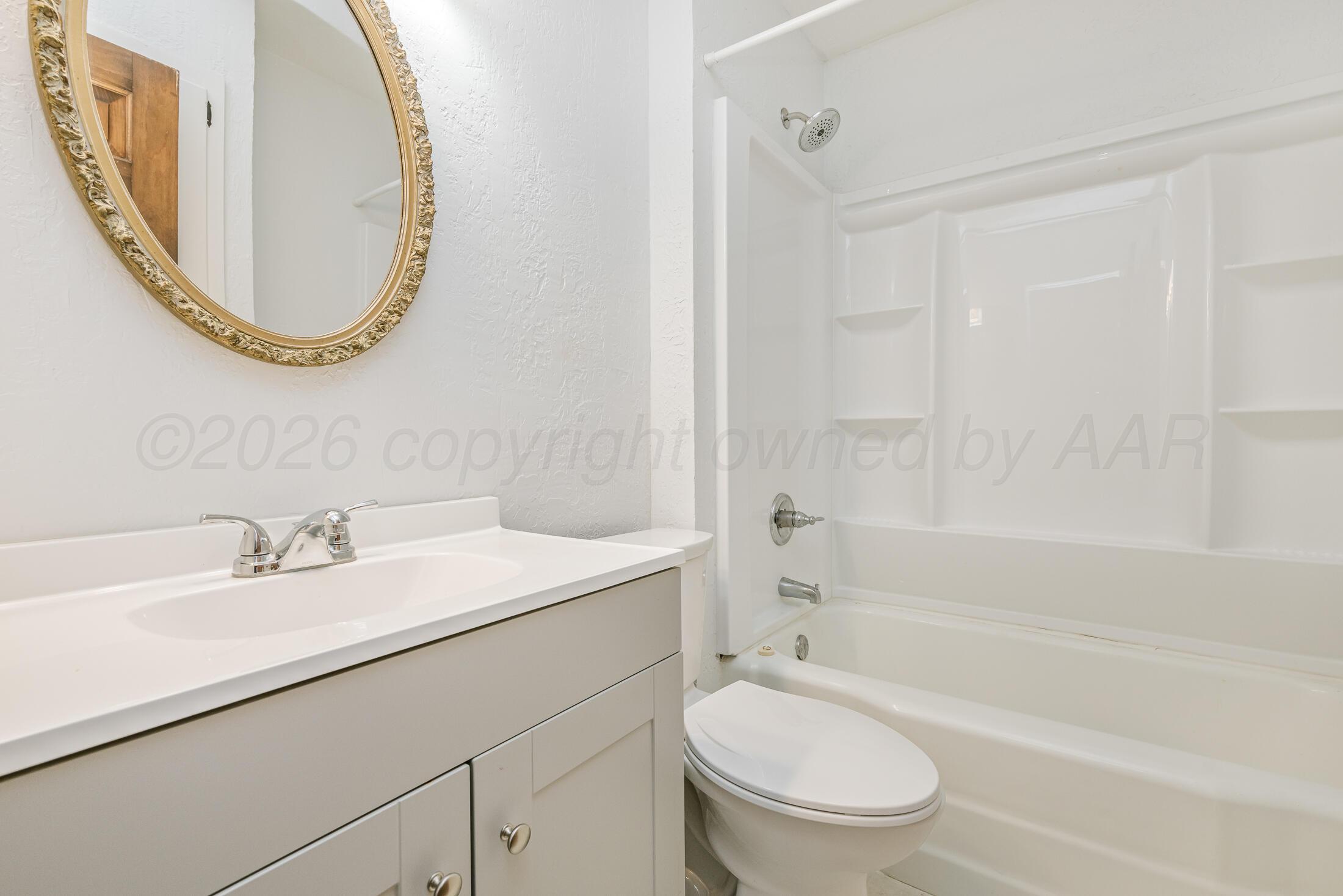 5408 George Terrace Amarillo, TX 79106 - Photo 21 of 26 a bathroom with a sink a toilet and a mirror