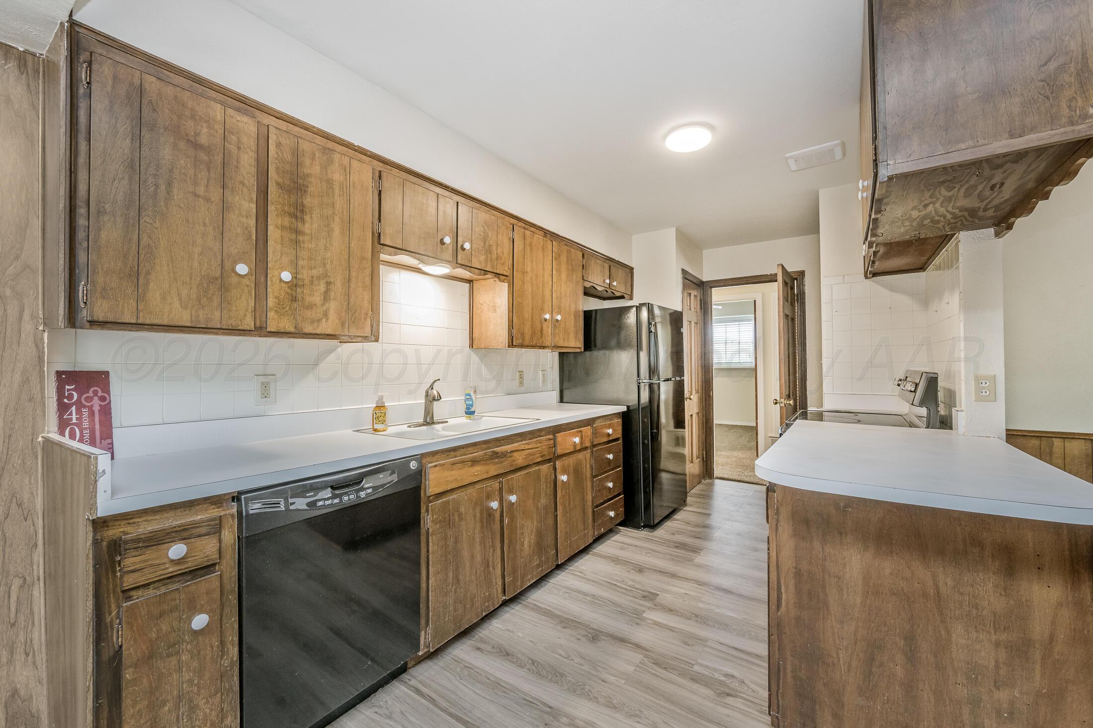 5408 George Terrace Amarillo, TX 79106 - Photo 10 of 26 a kitchen with a sink and cabinets