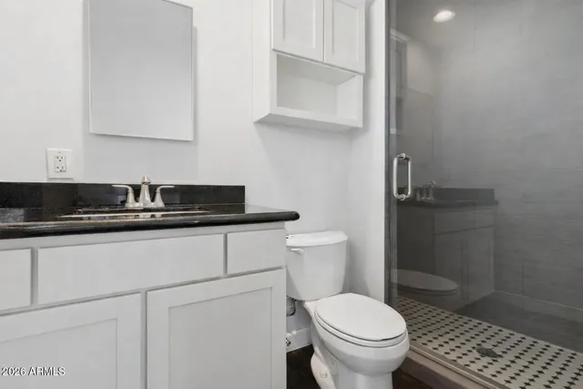 a bedroom with bed and a chandelier