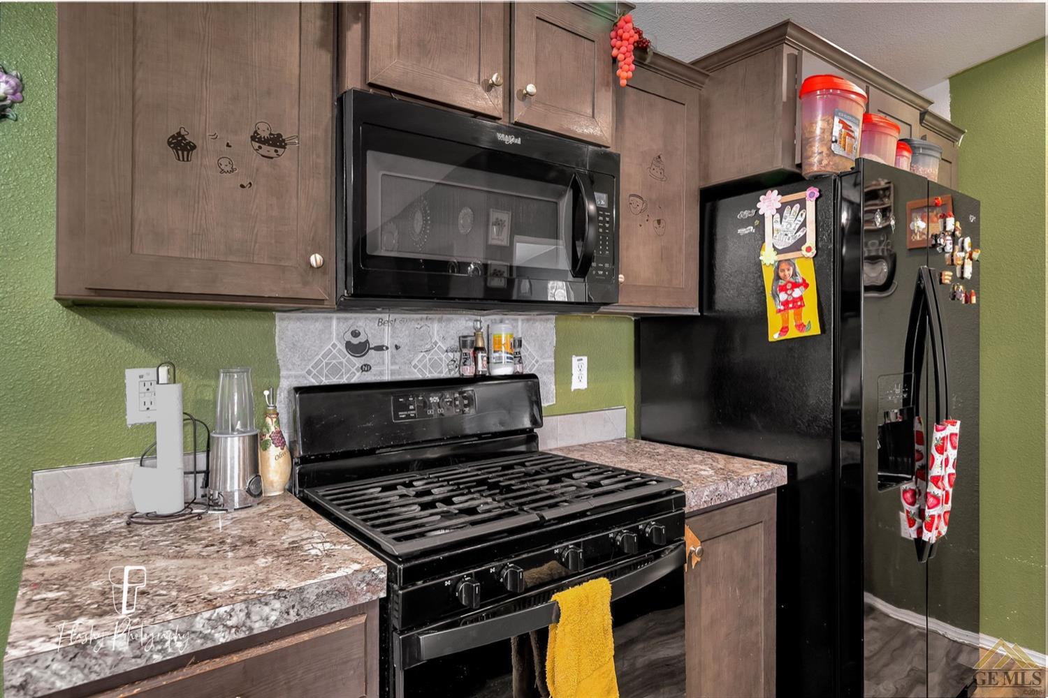 Undisclosed Address Bakersfield, CA 93308 - Photo 14 of 32 a kitchen with stainless steel appliances granite countertop a stove and cabinets