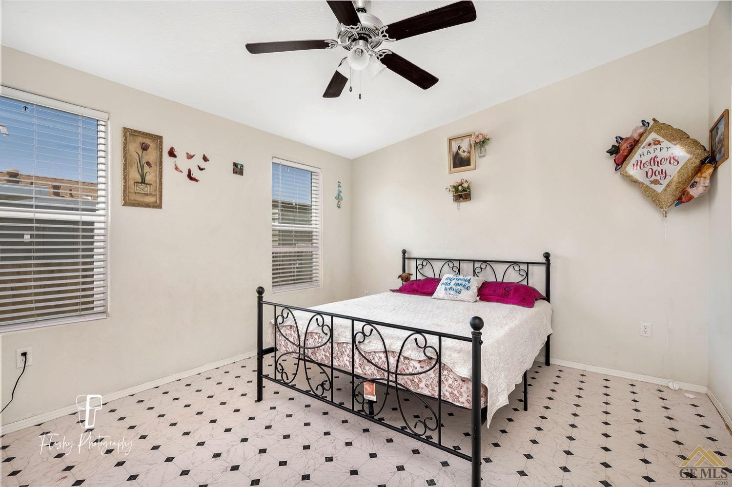 Undisclosed Address Bakersfield, CA 93308 - Photo 16 of 32 a bedroom with a bed and a dresser