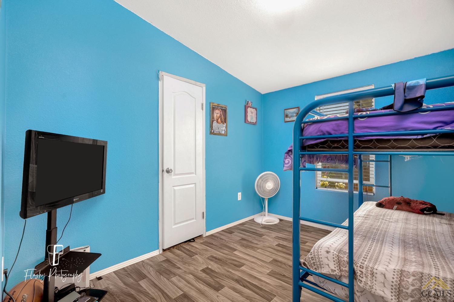 Undisclosed Address Bakersfield, CA 93308 - Photo 21 of 32 a bedroom with a bed and a bookshelf