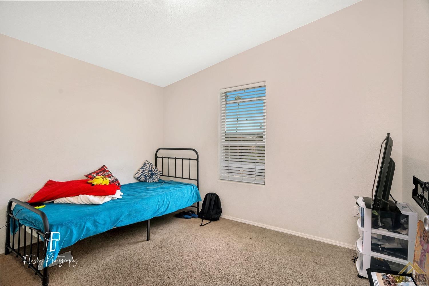 Undisclosed Address Bakersfield, CA 93308 - Photo 24 of 32 a bedroom with a bed and a window