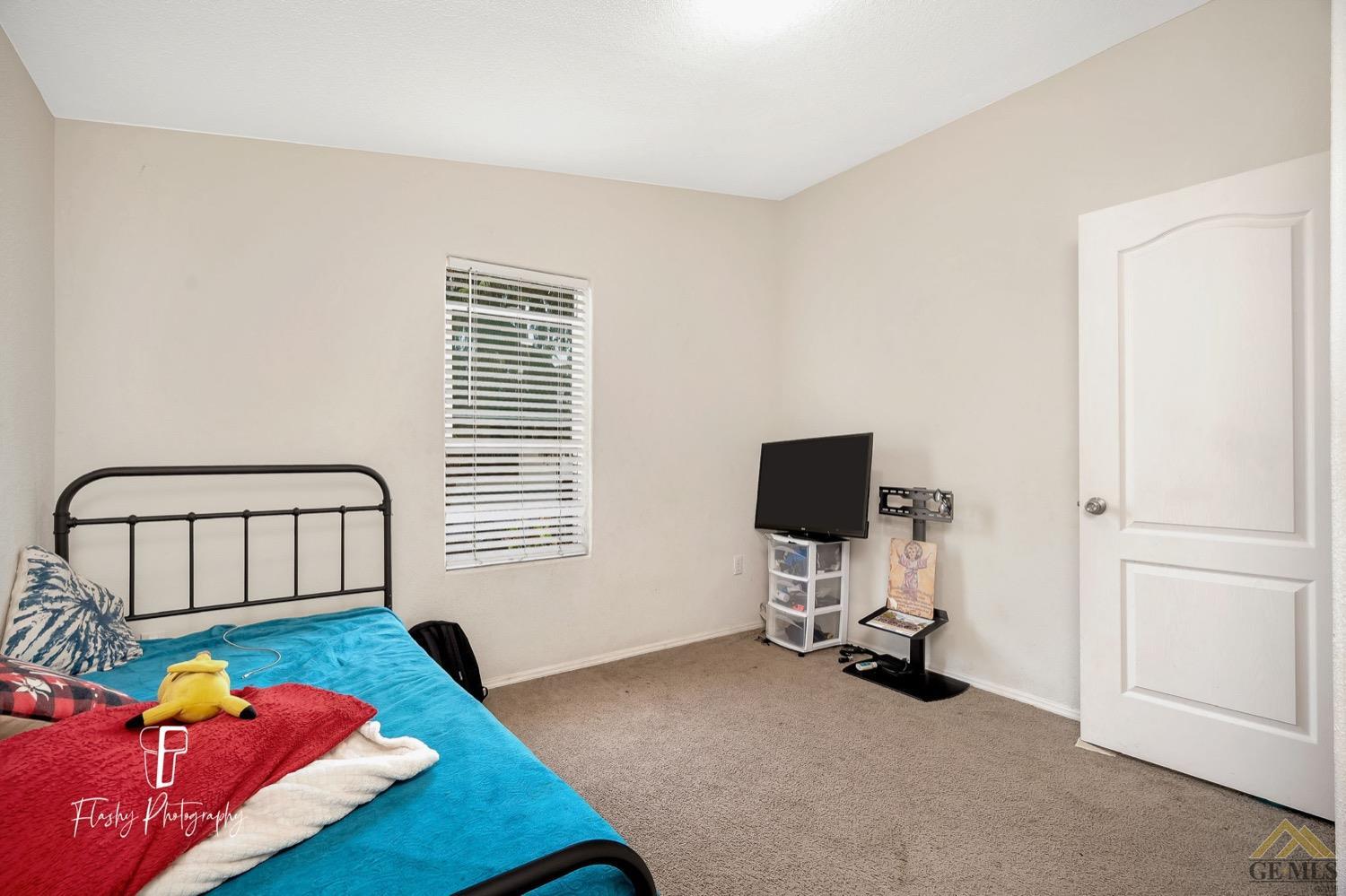 Undisclosed Address Bakersfield, CA 93308 - Photo 25 of 32 a bedroom with a bed and a window