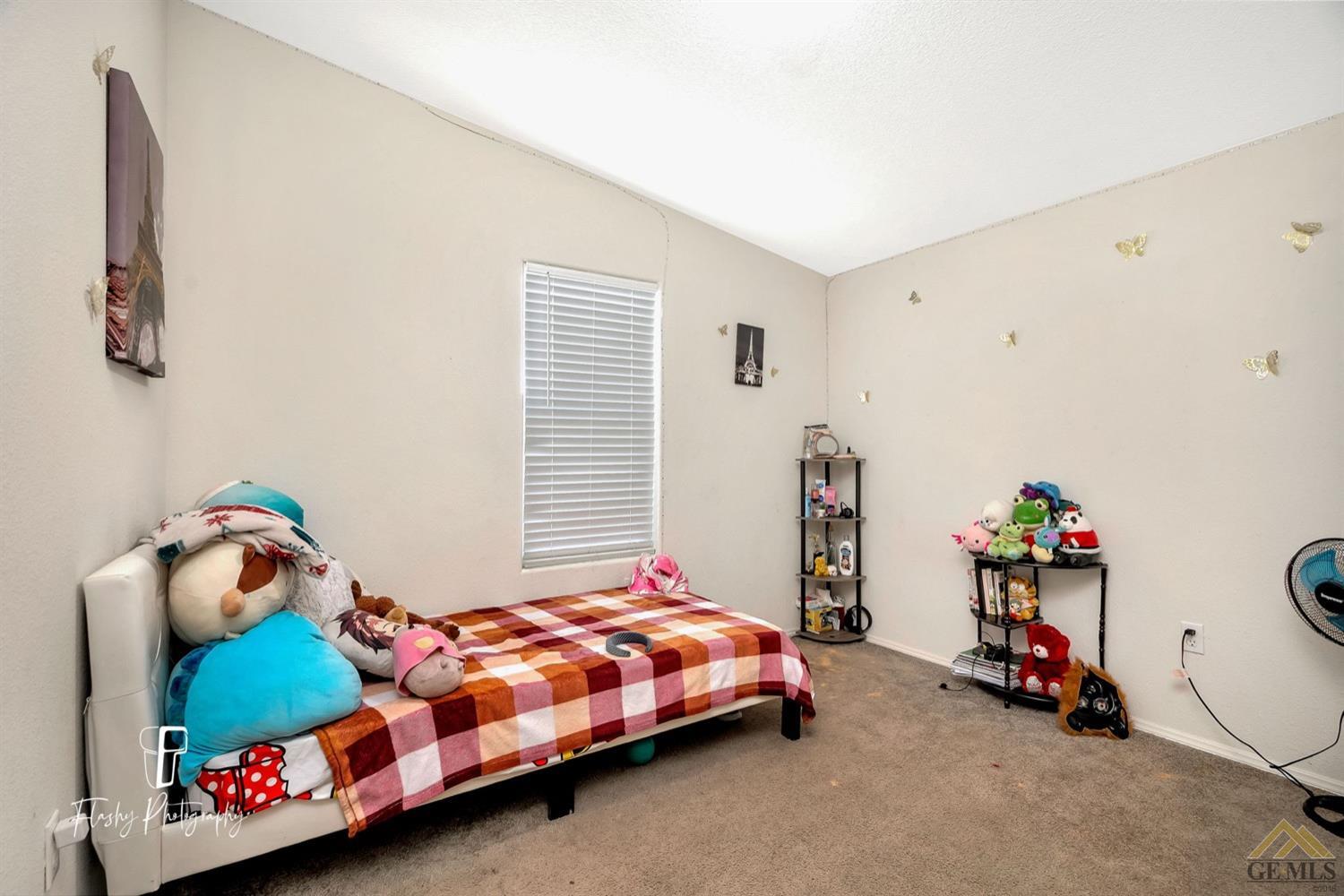 Undisclosed Address Bakersfield, CA 93308 - Photo 26 of 32 a bedroom with a bed and a window