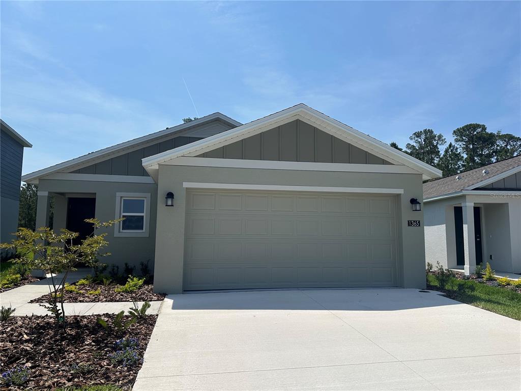 1365 Acorn Mdw Loop Eustis, FL 32726 - Photo 1 of 1 a front view of a house with garden
