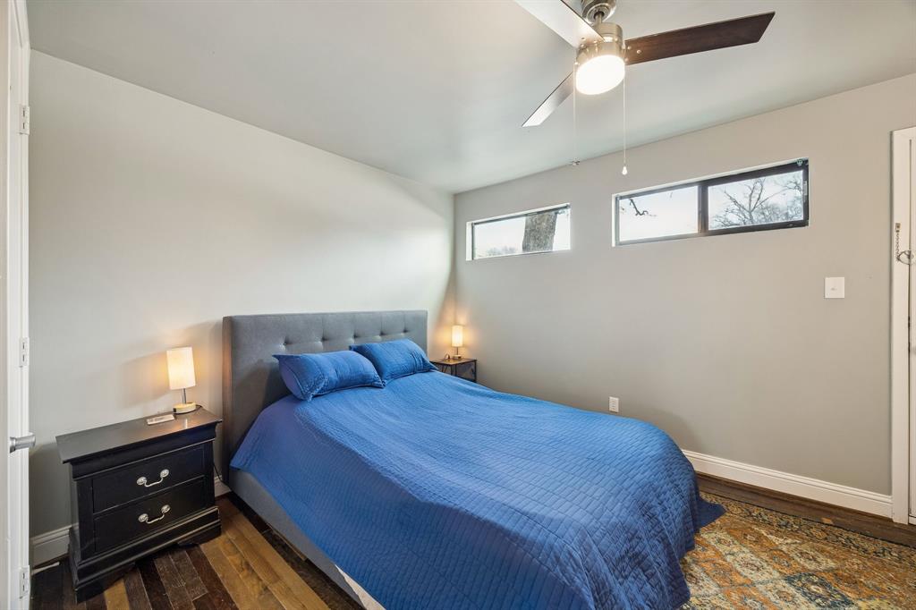 1804 Gould Street, Unit 3 Dallas, TX 75215 - Photo 18 of 19 a bedroom with a bed and wooden floor