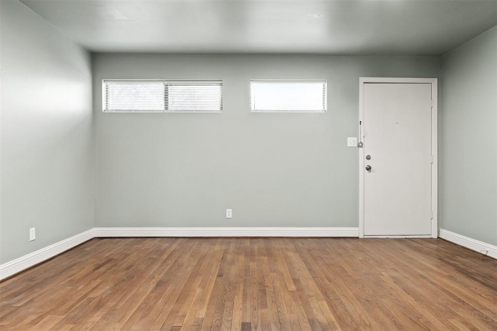 1804 Gould Street, Unit 3 Dallas, TX 75215 - Photo 4 of 19 a view of an empty room with wooden floor and a window