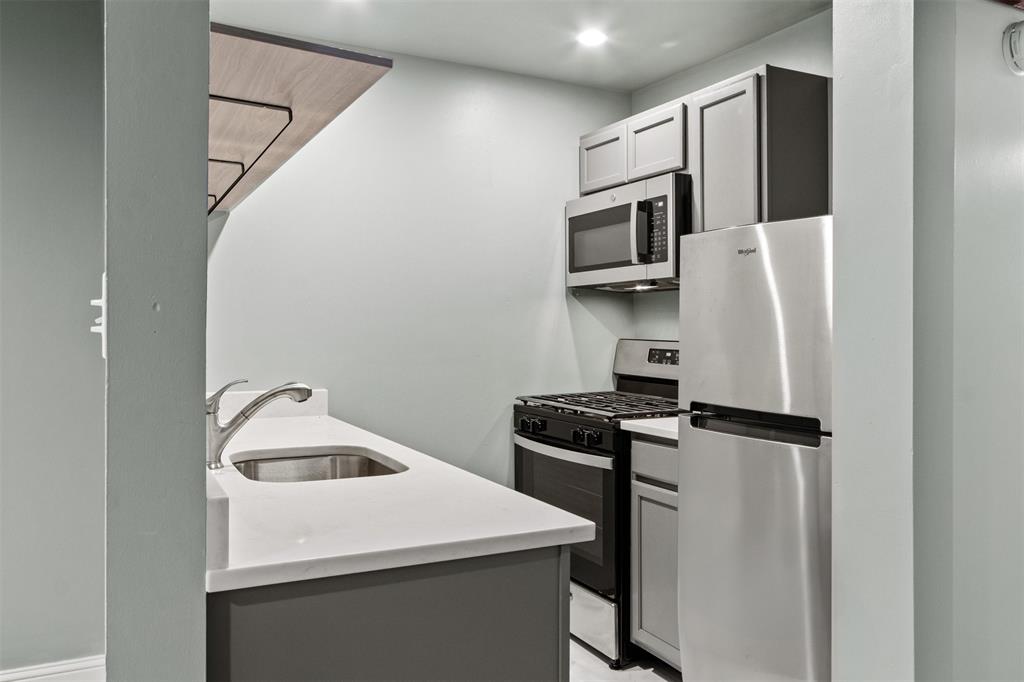 1804 Gould Street, Unit 3 Dallas, TX 75215 - Photo 6 of 19 a kitchen with stainless steel appliances a refrigerator stove and microwave