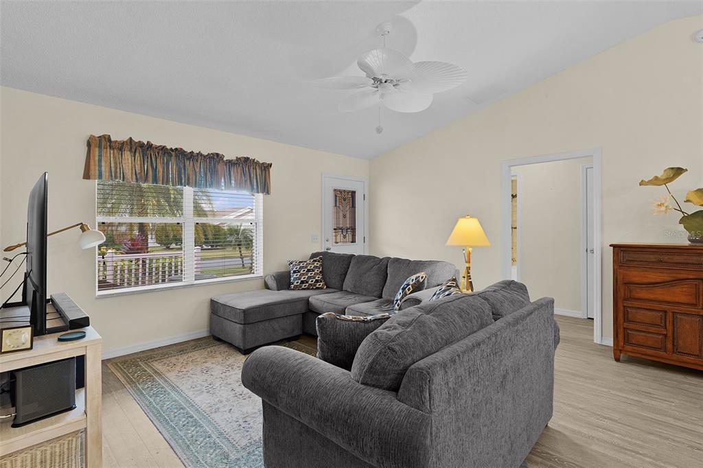 2583 Raintree Drive The Villages, FL 32162 - Photo 14 of 56 a living room with furniture a fireplace and a flat screen tv