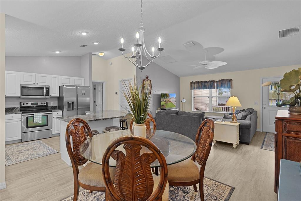 2583 Raintree Drive The Villages, FL 32162 - Photo 17 of 56 a dining room with furniture a large window and stainless steel appliances