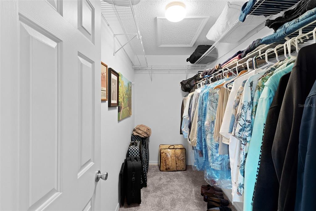 2583 Raintree Drive The Villages, FL 32162 - Photo 30 of 56 a view of walk in closet with clothes and shoes